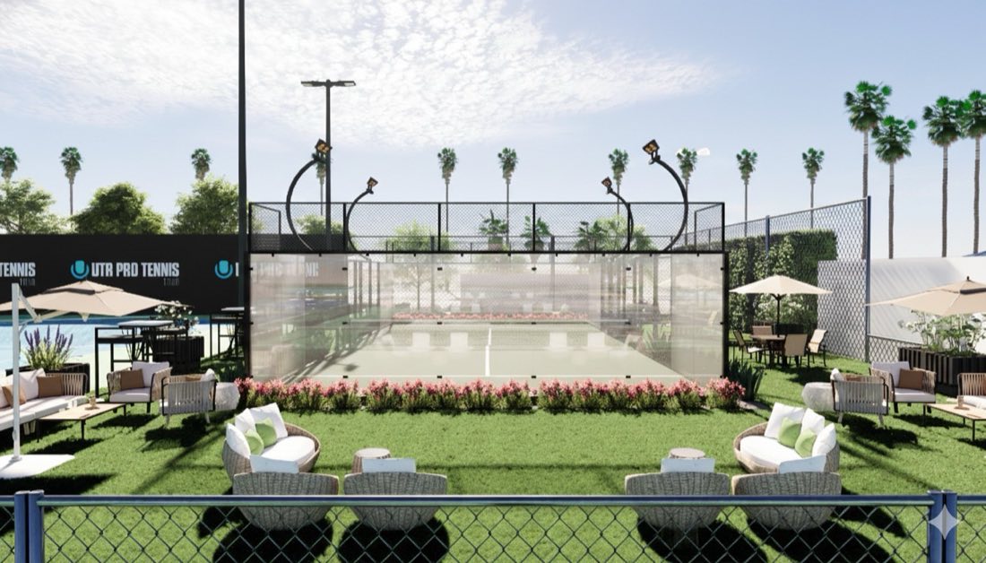 The new padel court at TTC Newport Beach, glass-walled and surrounded by lawn seating and umbrellas.