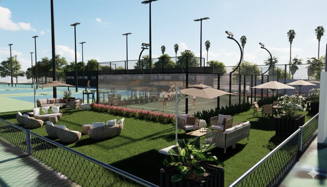 Lounge seating and shaded tables on the lawn beside the padel court, with players mid-rally.
