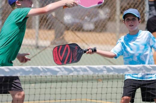 Junior players on court at TTC Newport Beach